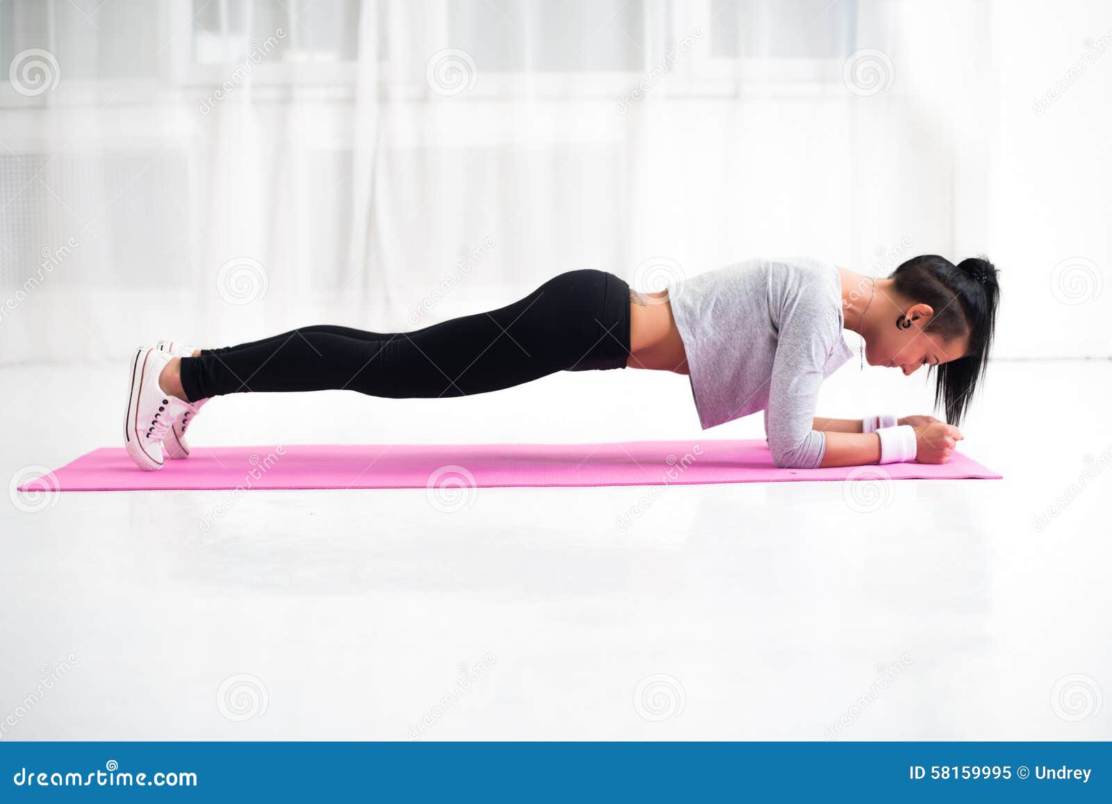 slim fit girl doing planking core muscles exercise