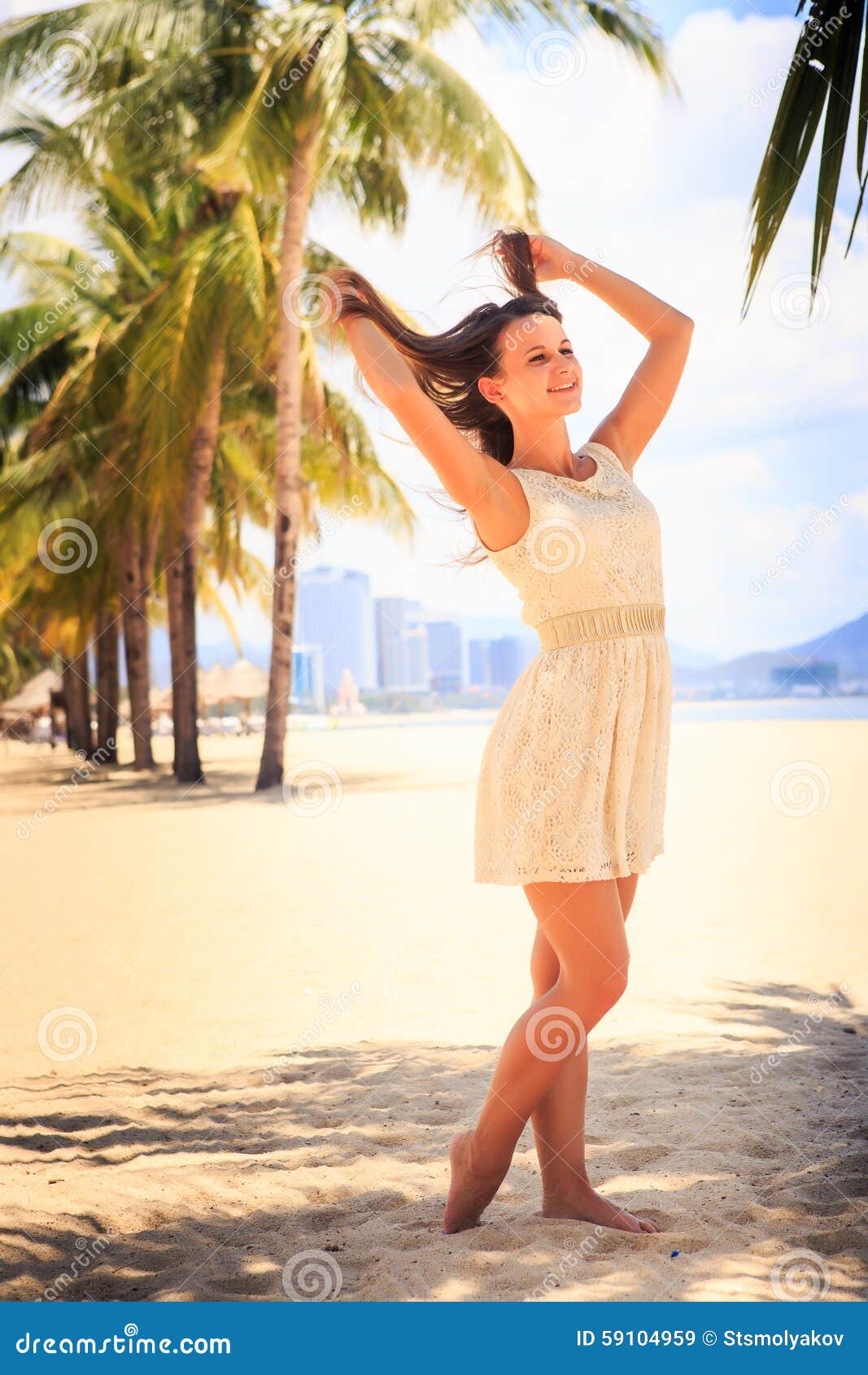 Young Brunette Girl In Short Grey Frock With Lace Poses By White Wall And  Smiles Against Defocused Sea And Mountains Stock Photo, Picture and Royalty  Free Image. Image 44695145.