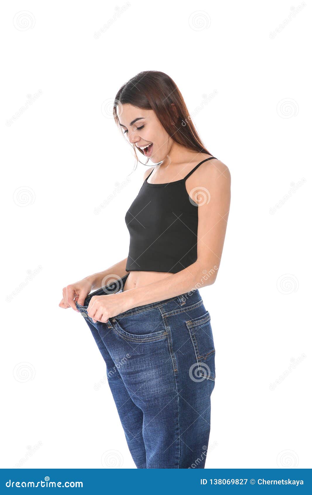 Slim Woman in Oversized Jeans on White Background. Stock Image - Image ...