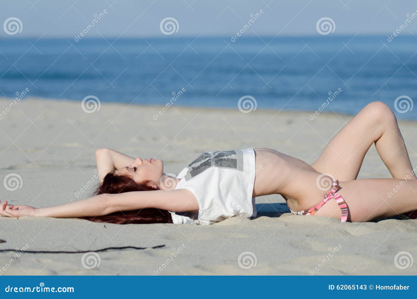 https://thumbs.dreamstime.com/z/slim-young-red-hair-woman-wearing-bottom-bikini-shirt-flaunt-her-attractive-body-playful-sexy-poses-as-lie-sandy-62065143.jpg