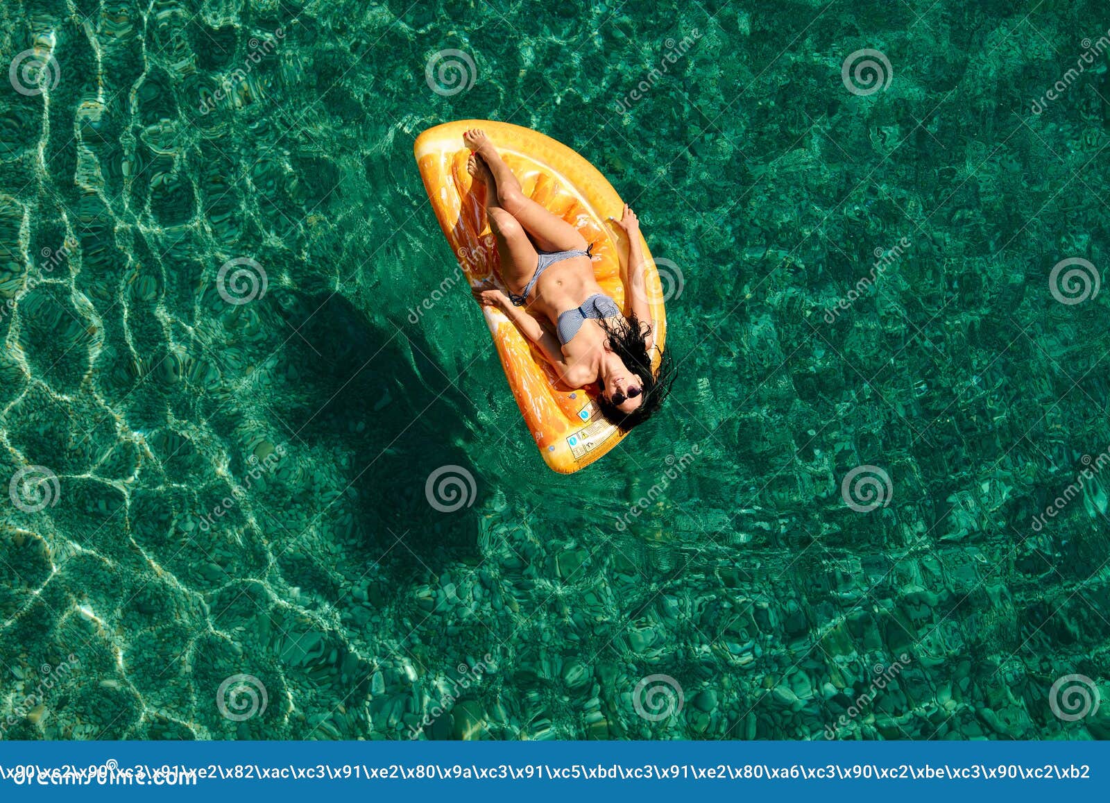 Slim Young Woman in Bikini and Sunglasses on the Air Mattress Floats in ...