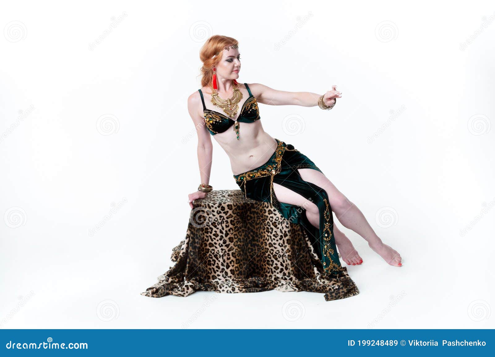 Slim Young Woman in Green Decorated Belly Dance Costume Sitting and Looking  at Golden Bracelets on Pedestal Stock Image - Image of bracelets,  performer: 199248489