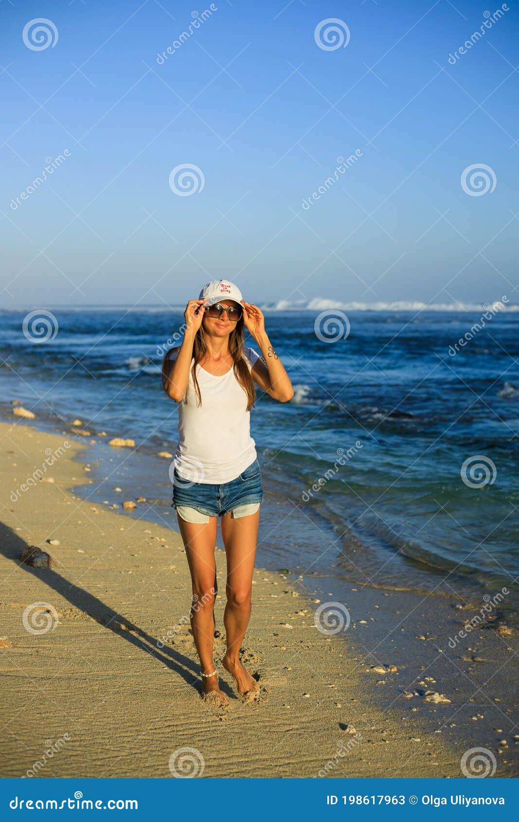 Slim Young Woman Walking Barefoot Along the Beach. Caucasian Woman ...