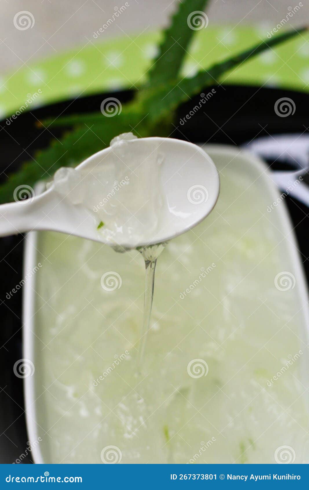 aloe vera leaf slime sliding down the spoon