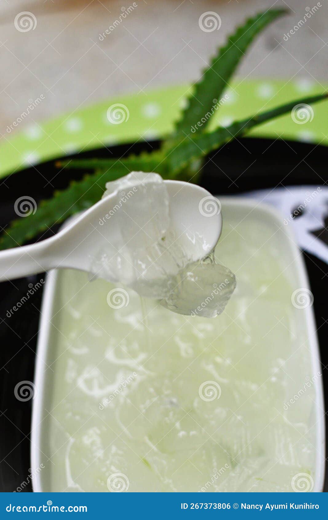 spoon with aloe vera slime in bowl