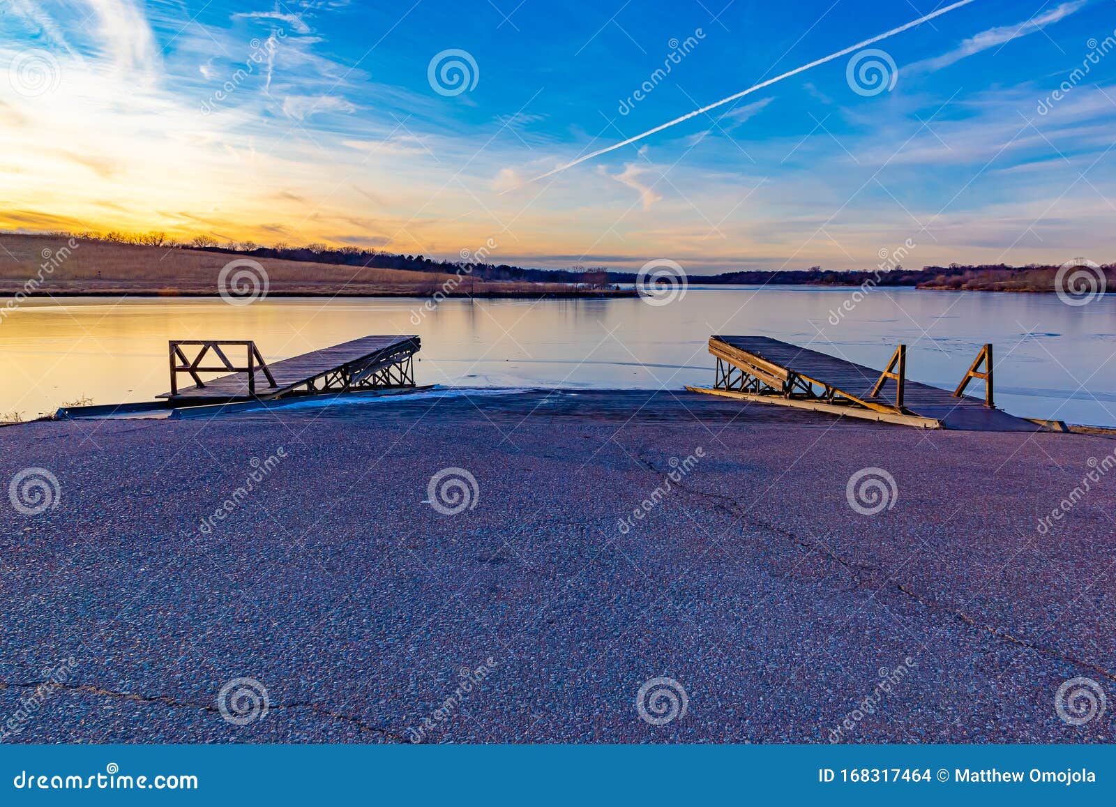 slipway or boat ramp on ed zorinsky lake at sunset stock