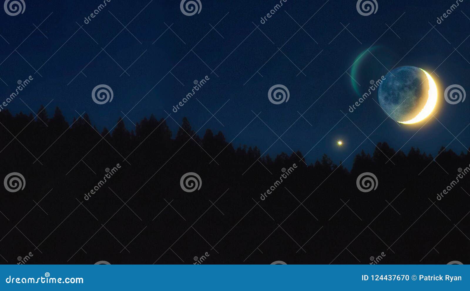 sliver moon and mars over silhouette of forested mountains