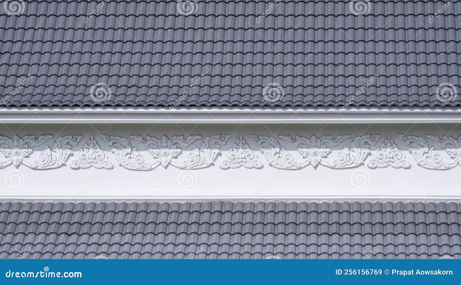 slope angle view of curve gray concrete tiles roof with white traditional kranok pattern on thai temple roof