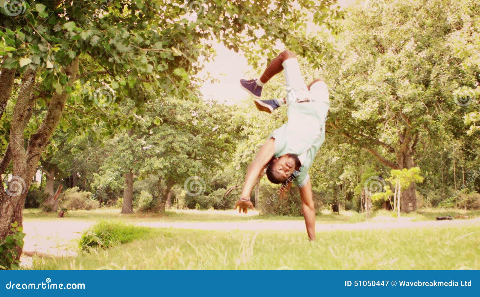 In Slow Motion Cool Young Break Dancer Doing Back Flip in the Park