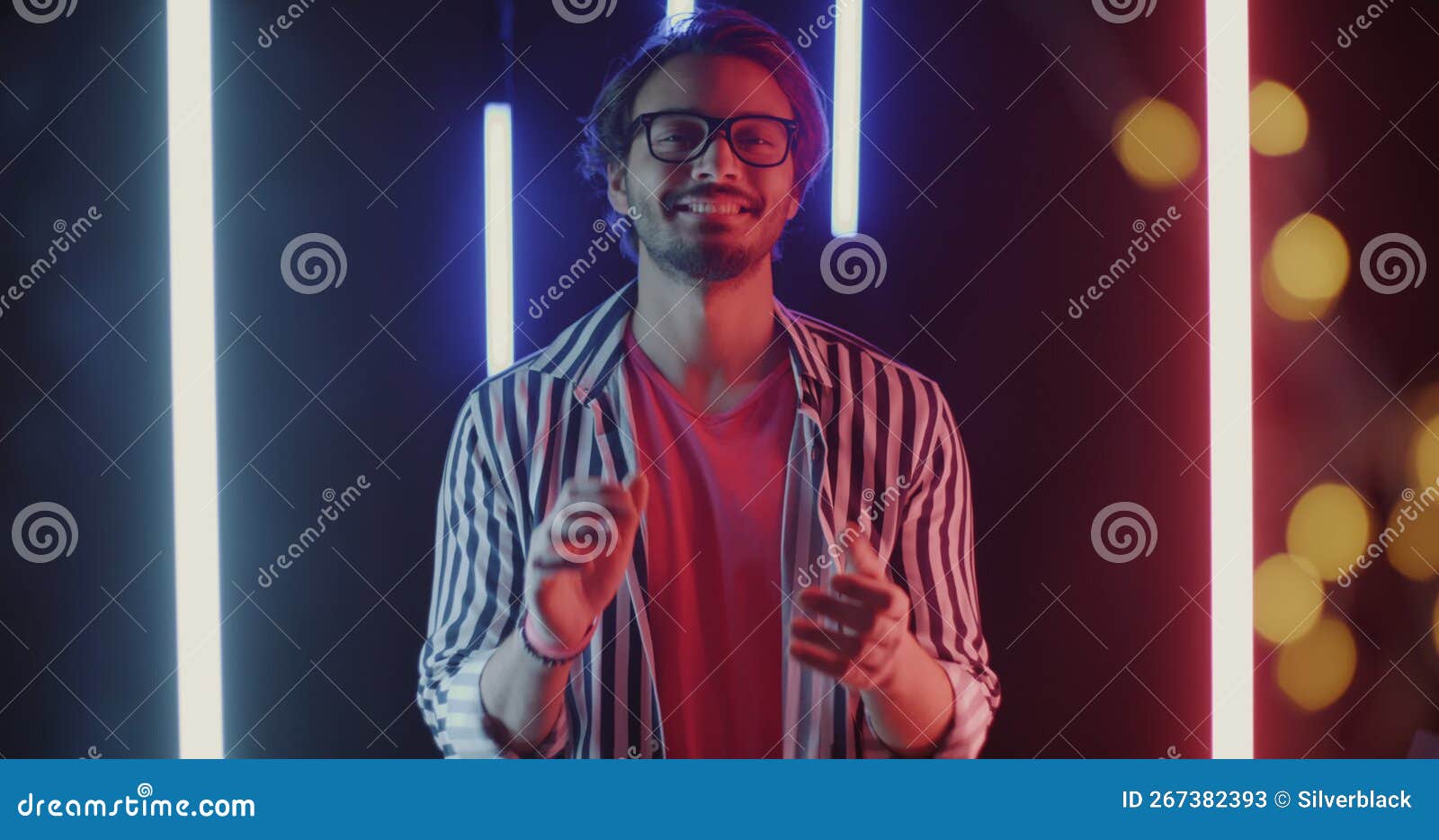 Slow Motion Portrait of Joyful Guy Clapping Hands and Looking at Camera on  Beautiful Neon Background Stock Video - Video of praising, happy: 267382393