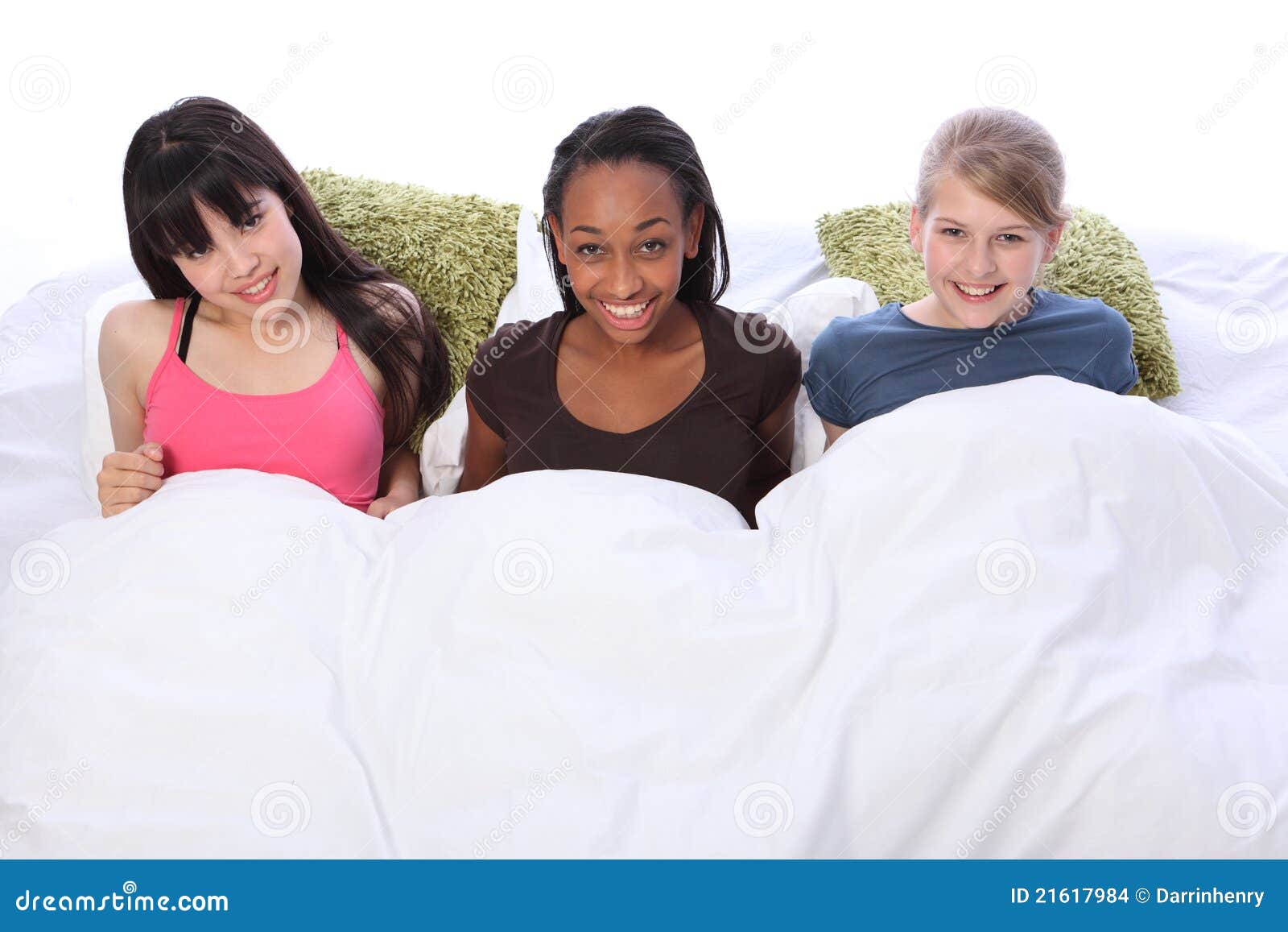 Slumber Party Fun Happy Teenage Girls in Bed Stock Photo