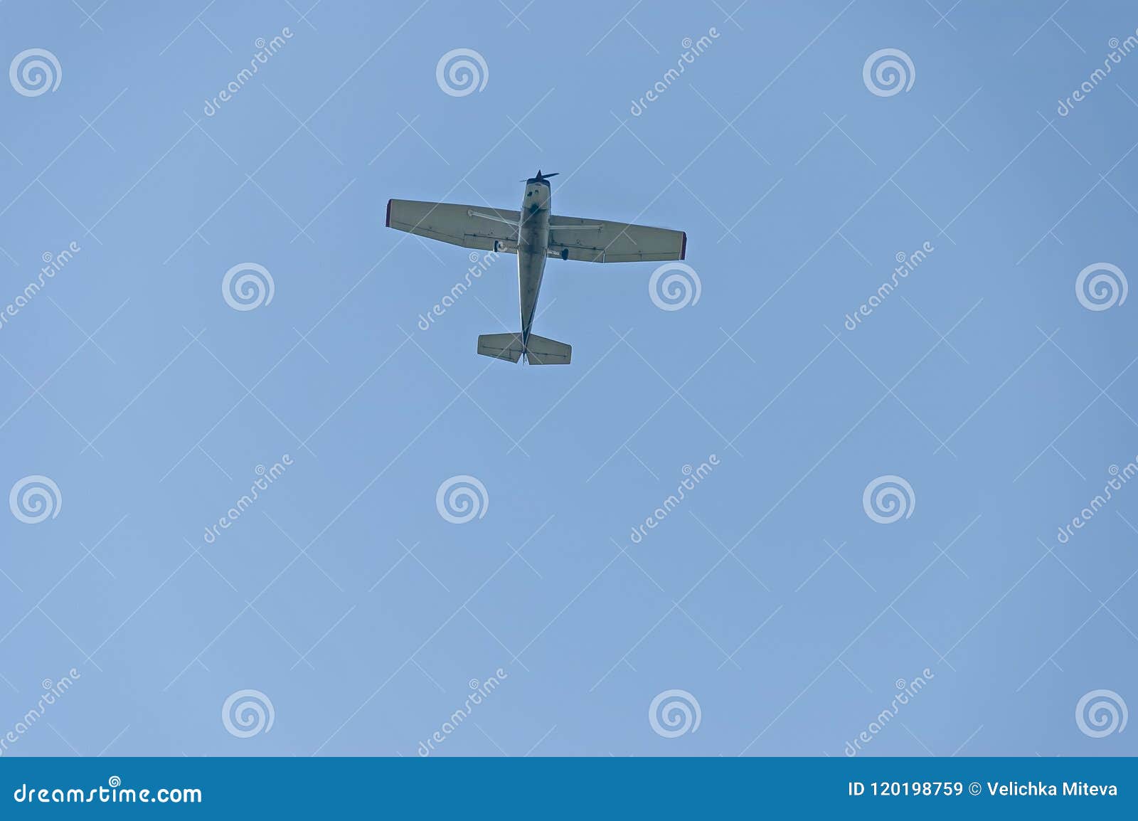 small aeroplane flying on blue sky background over sredna gora mountain