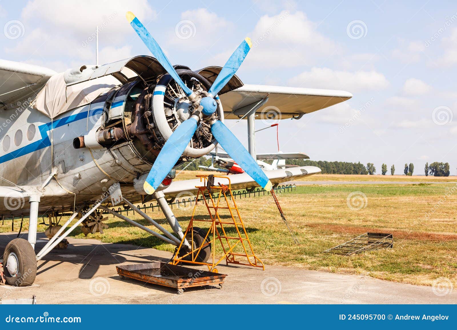 small aircraft with propeller in parking lot.