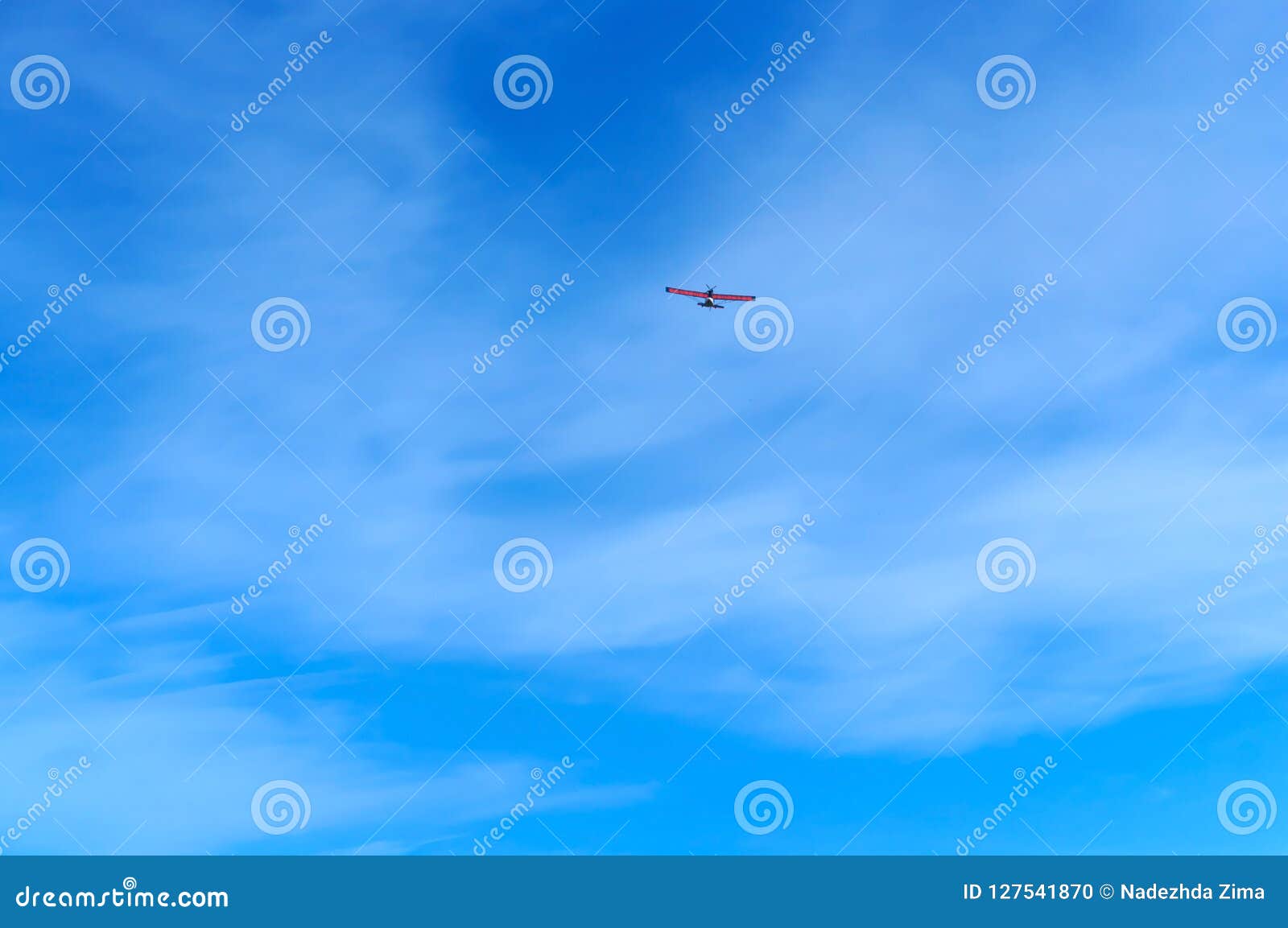 A Small Aircraft Soars in the Blue Sky, Glider in the Sky Stock Photo