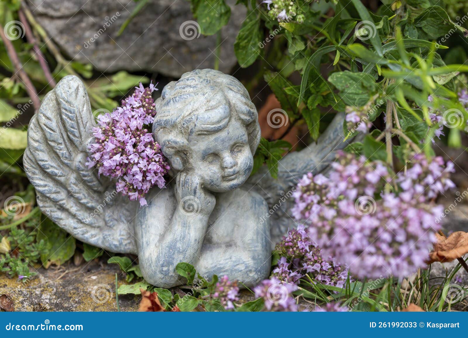 Small Angel Figurine in the Garden between Flowers Stock Image Image