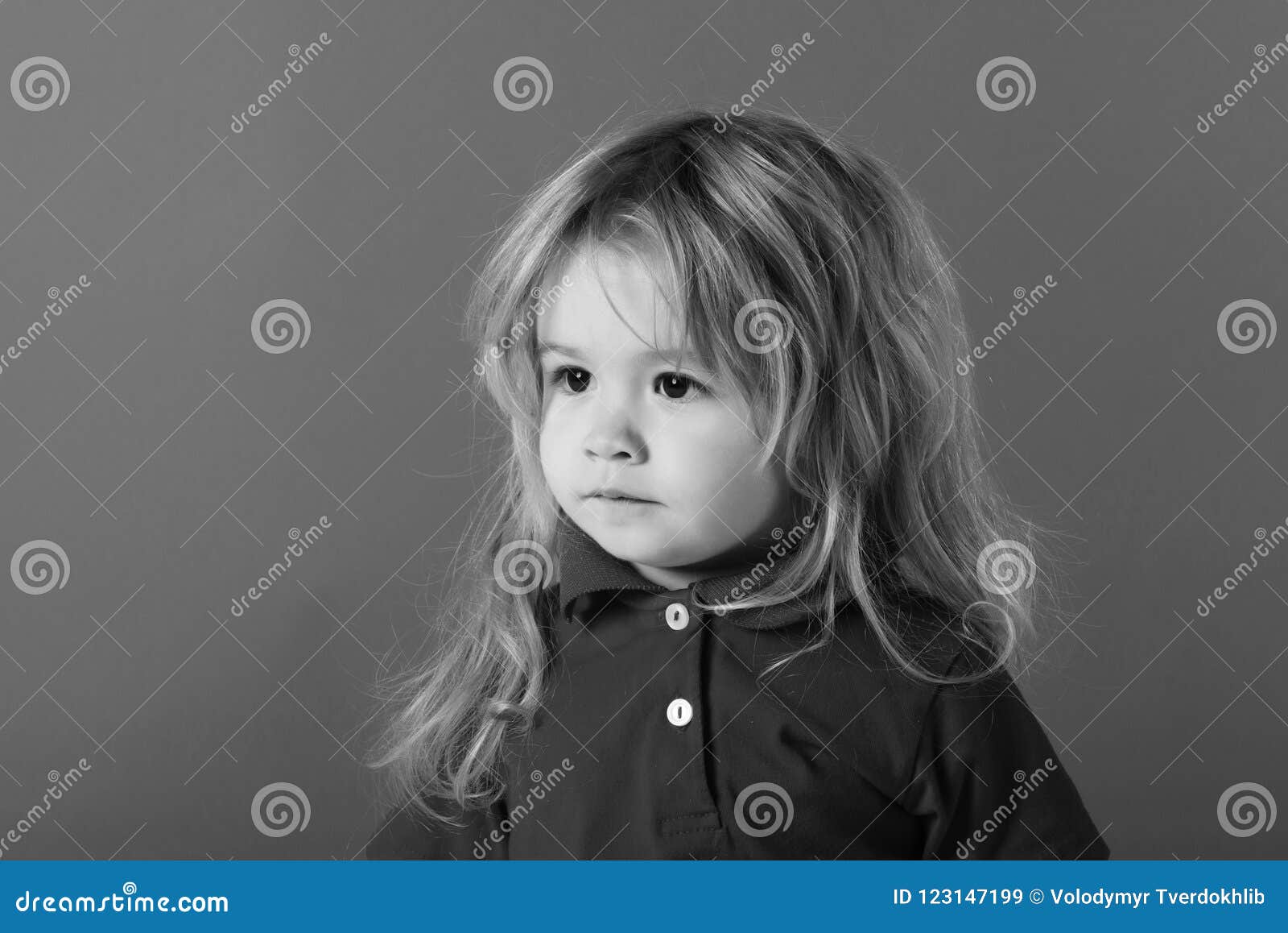 Small Baby Boy With Long Blonde Hair In Red Shirt Stock Image