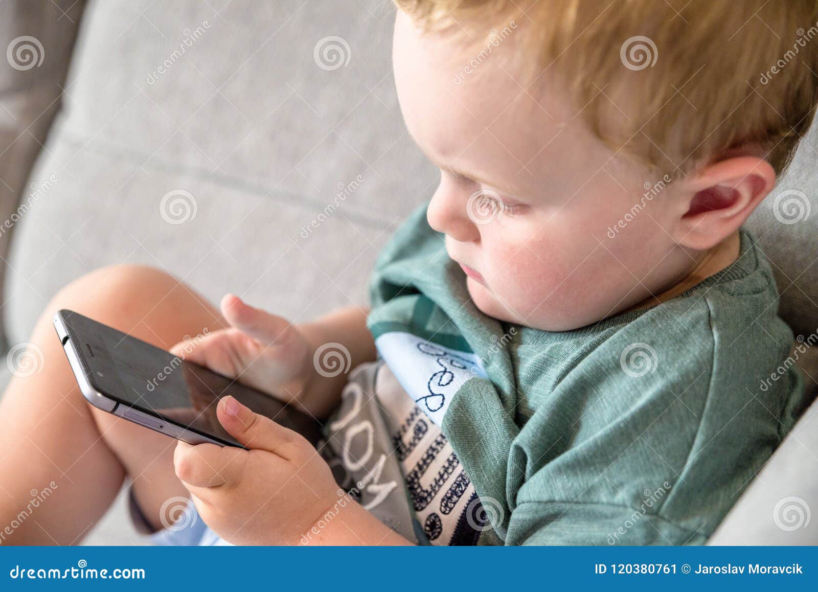 Baby with smartphone stock image. Image of looking, play 120380761