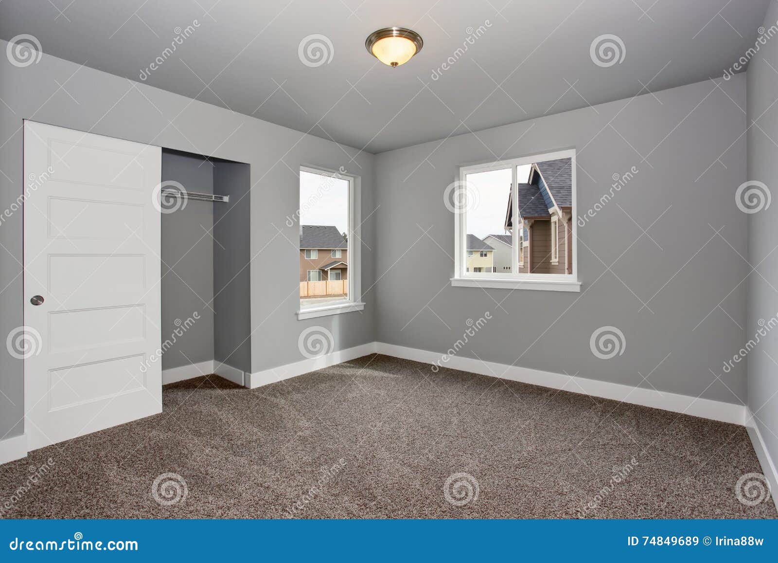 Small Basement Room Interior With Grey Walls And White Trim Stock