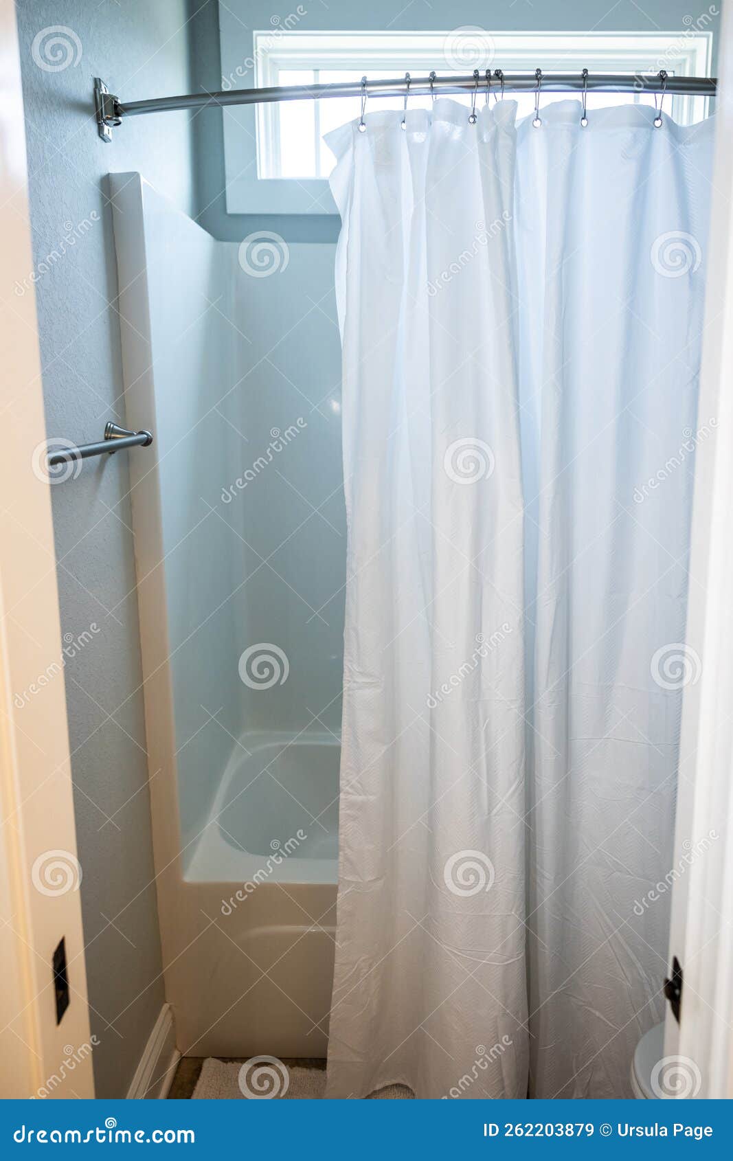 A Small Bathroom with a Bathtub Shower Insert with a Hanging White