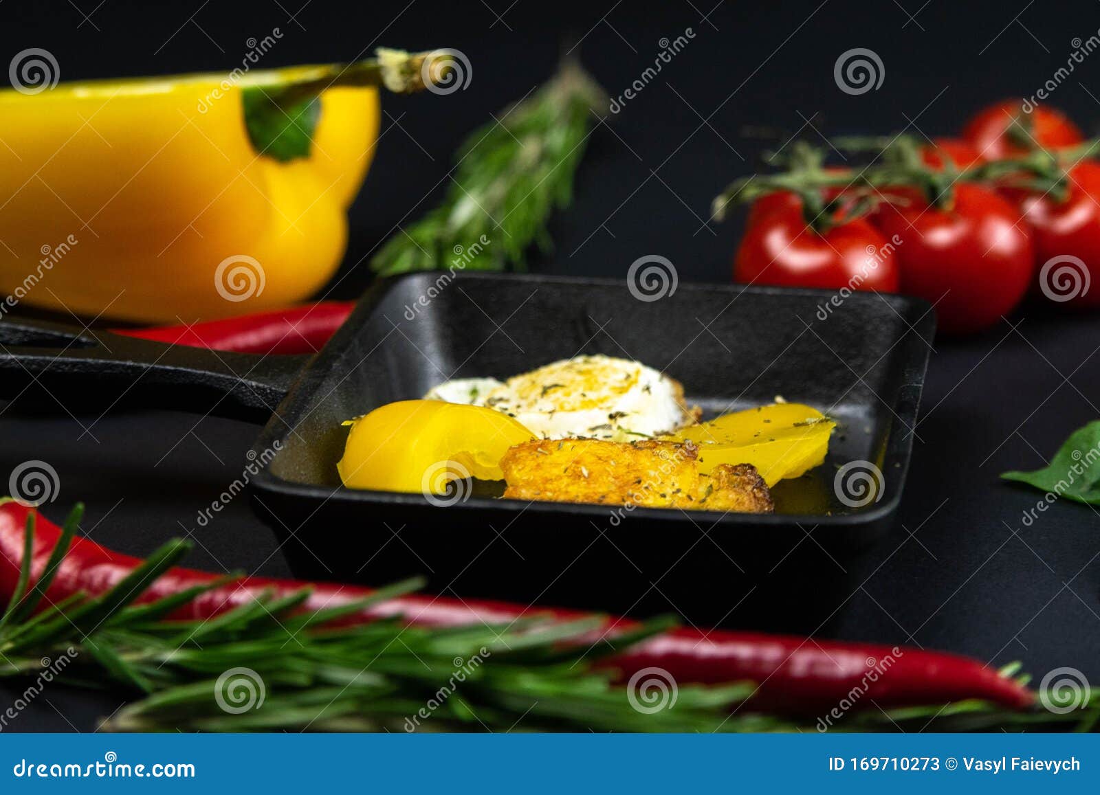 a small black frying pan with quail eggs in the  of a heart on the blacl background