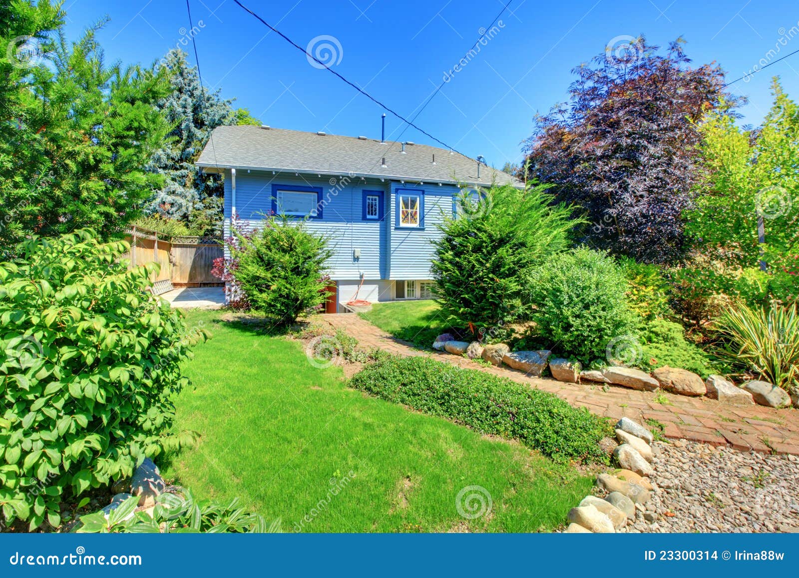 Small Blue House with Garden in Back Yard. Stock Photo Image of