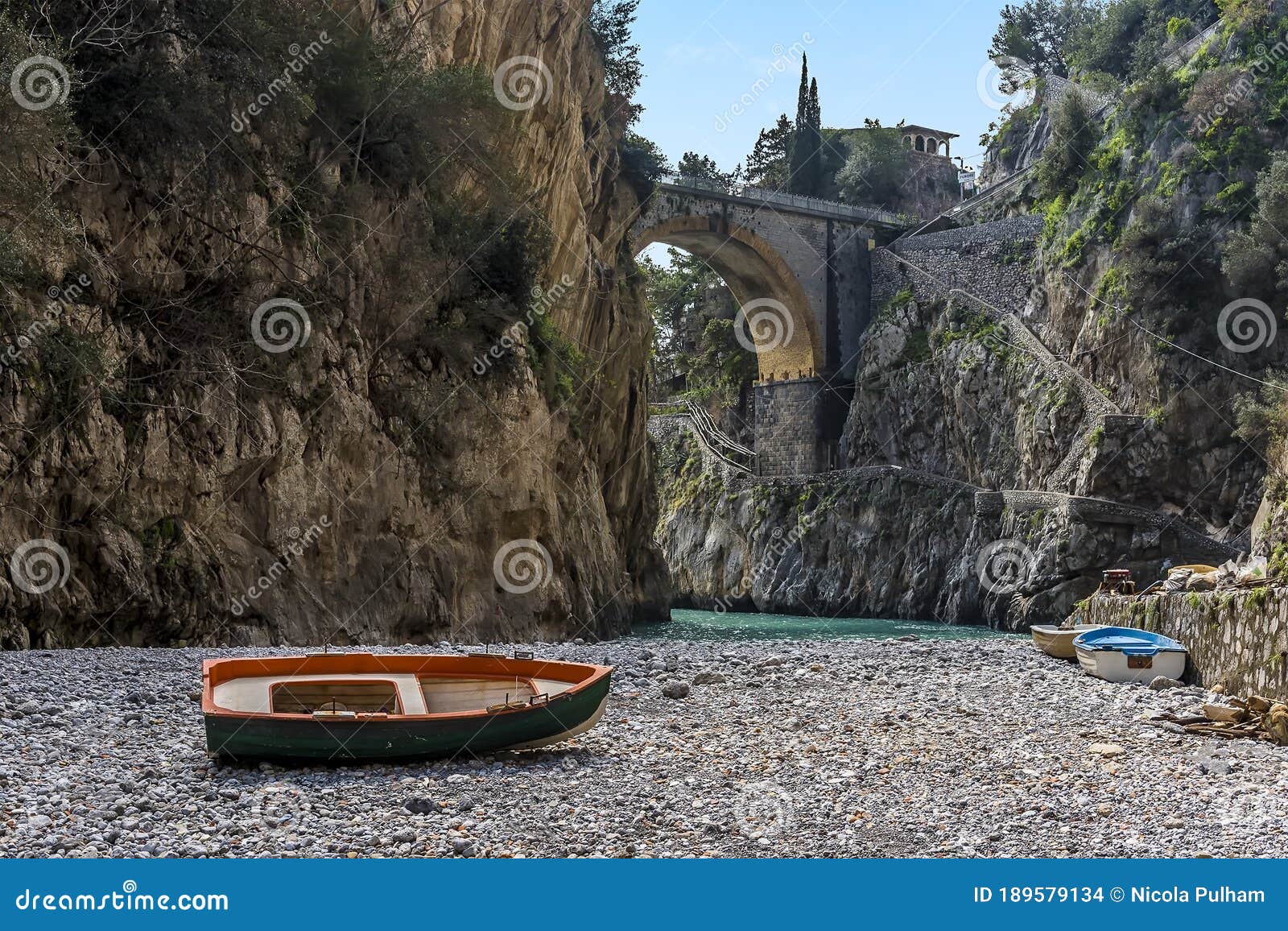 a small boat stands adrift on the shingle beach of fiordo di furore on the amalfi coast, italy