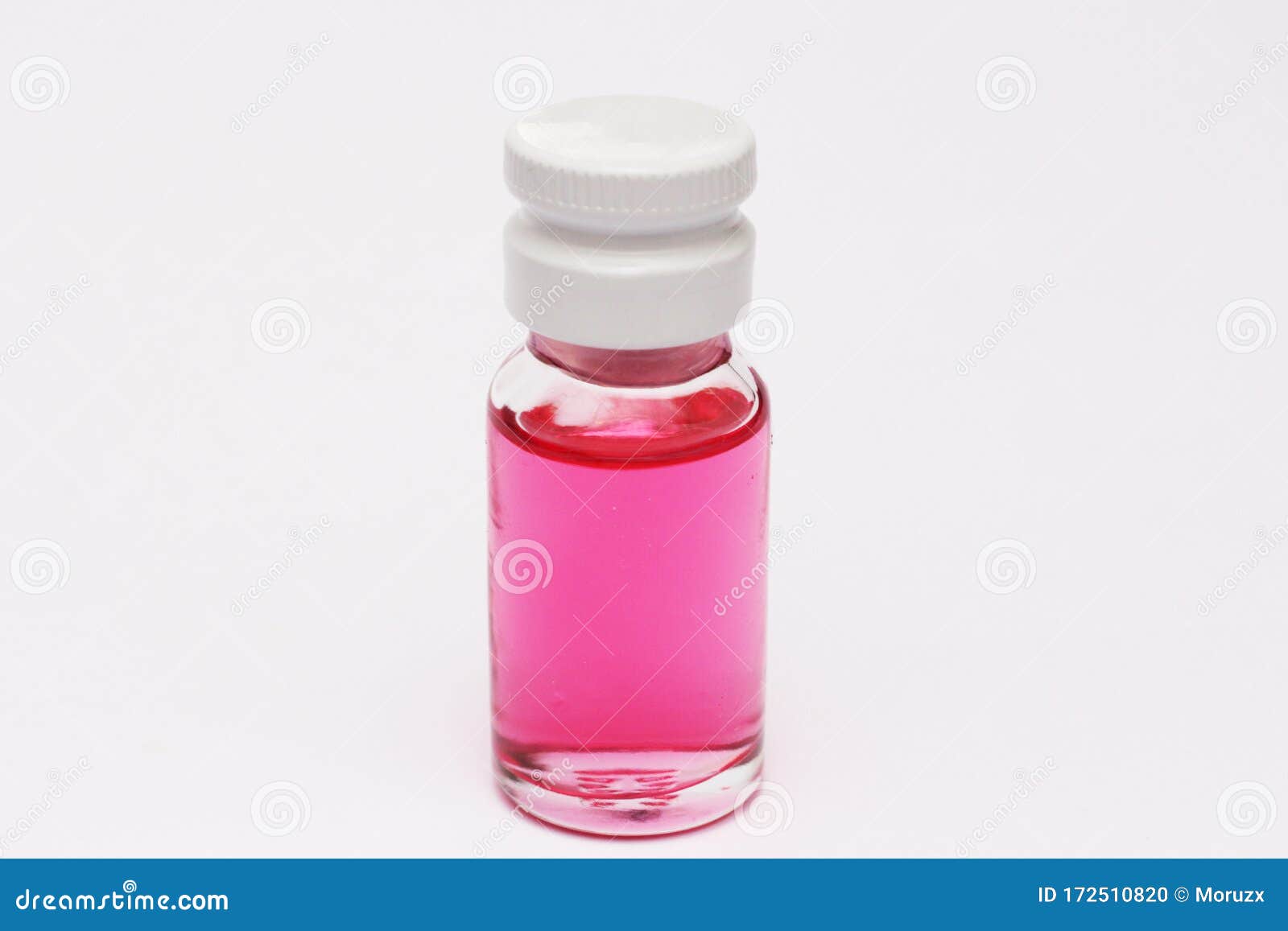 small bottle with red liquid inside. red colored fluid.