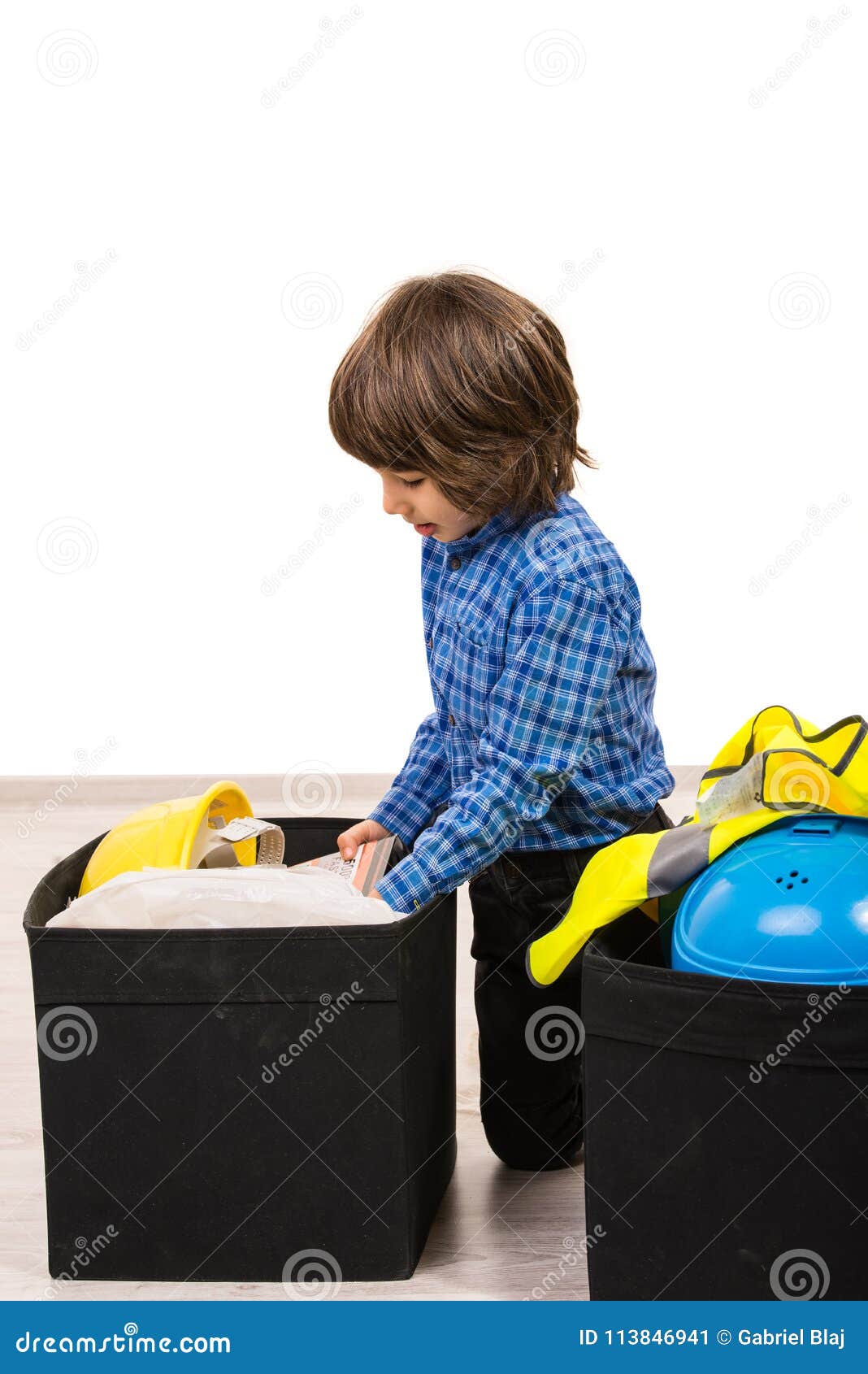 small boy arrange things in boxes