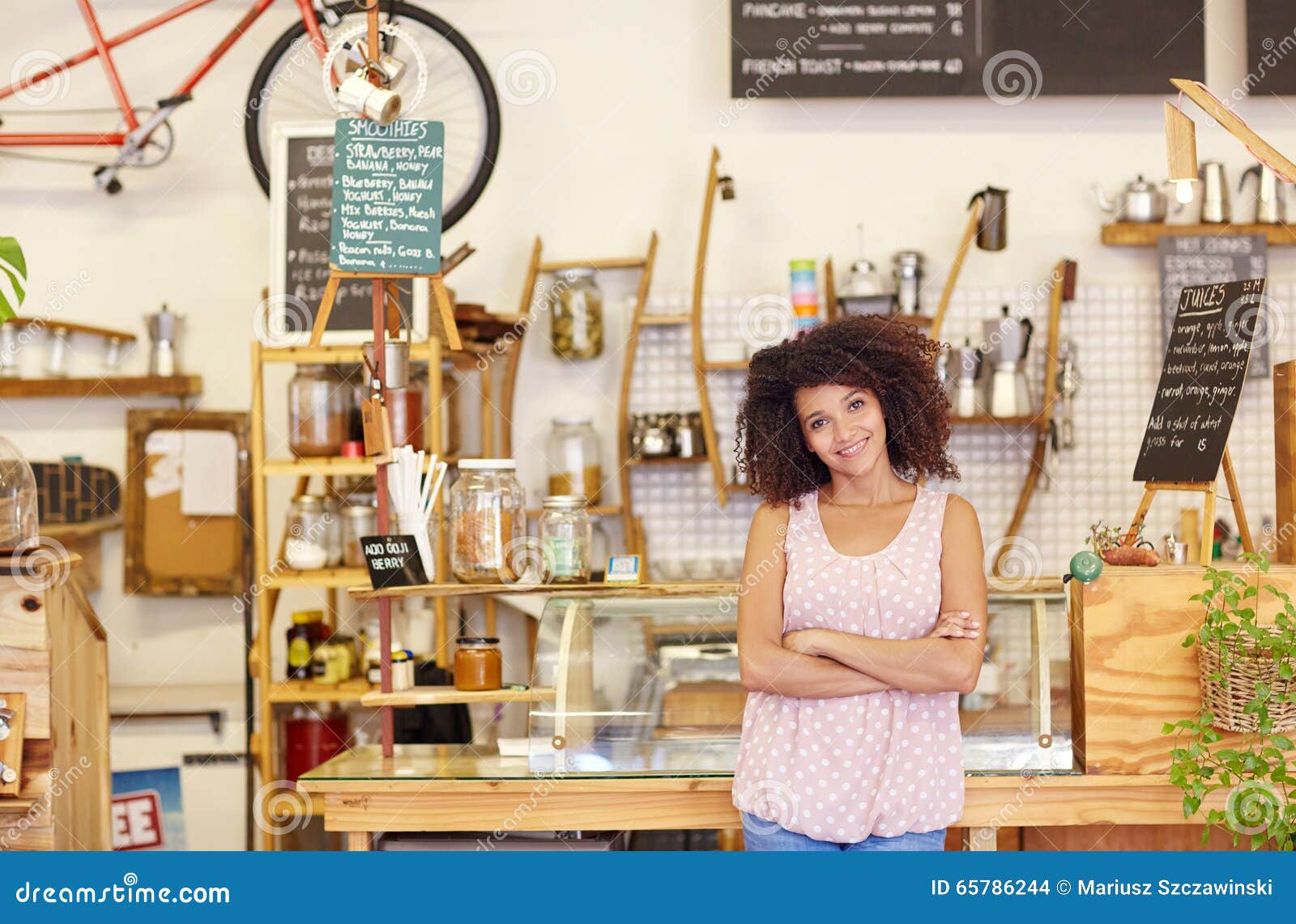 small business owner standing proudly in her coffee shop