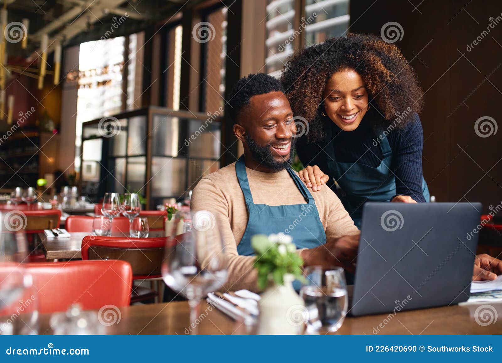 small business owners using laptop in restaurant