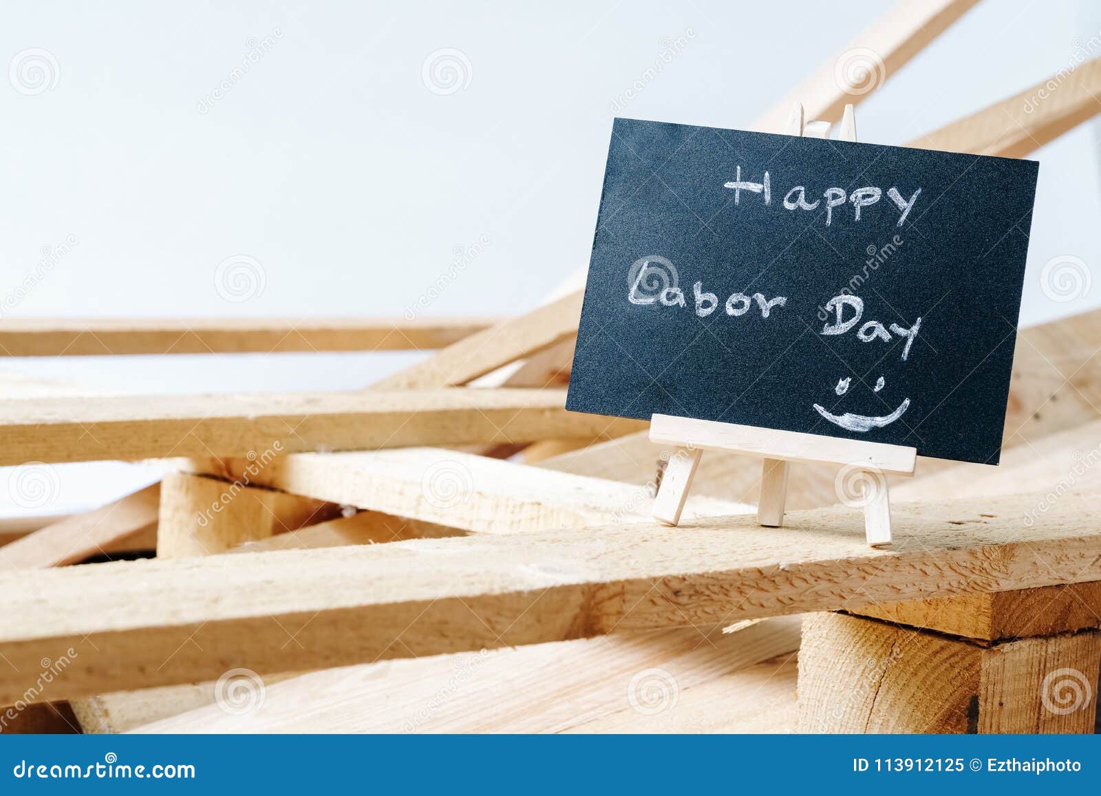 small chalk board with text happy labor day with wooden pallet b