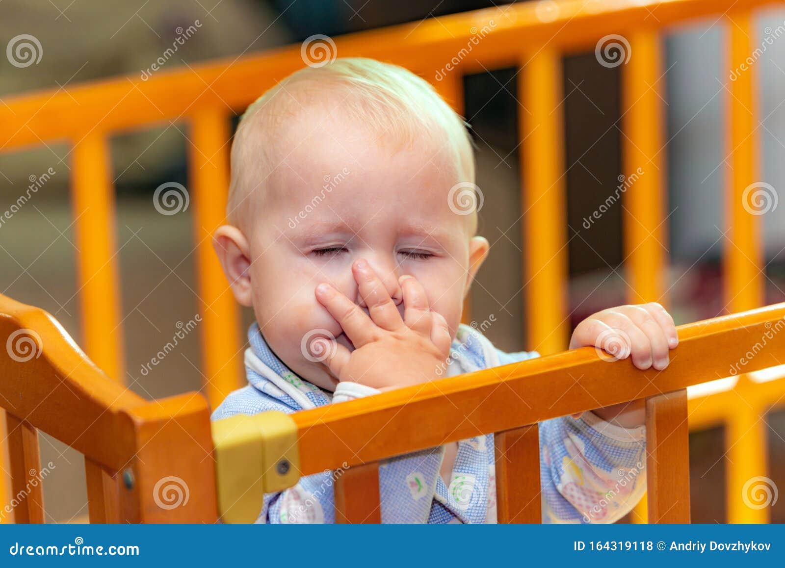 A Small Child Covers His Face with His Hand Stock Photo Image of