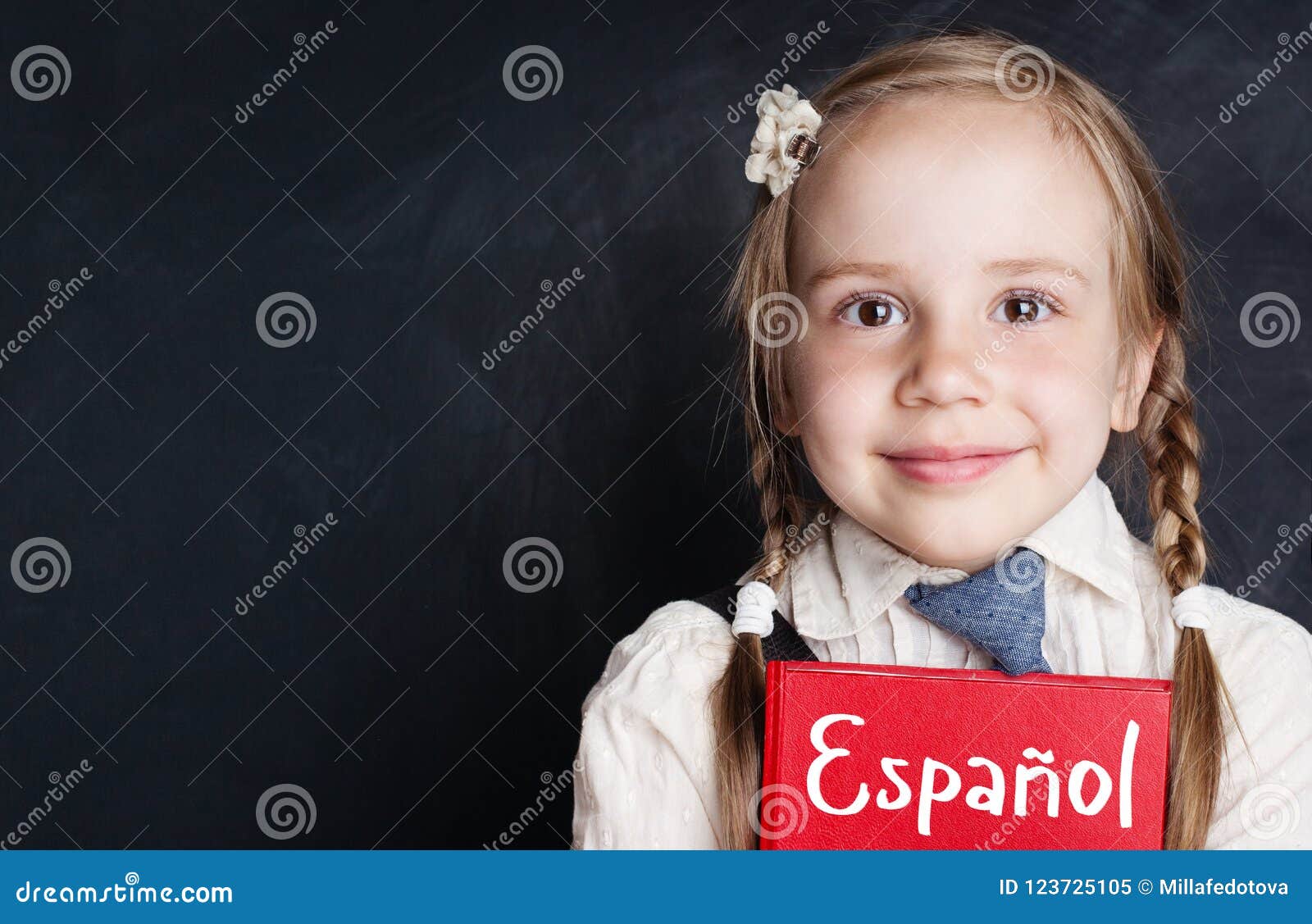 Small Child Student Learning Spanish at the Classroom Chalkboard Stock
