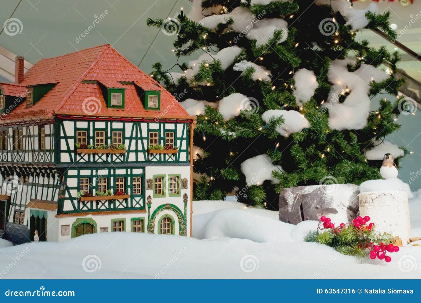 Small Christmas  House  Near  The Christmas  Tree With 