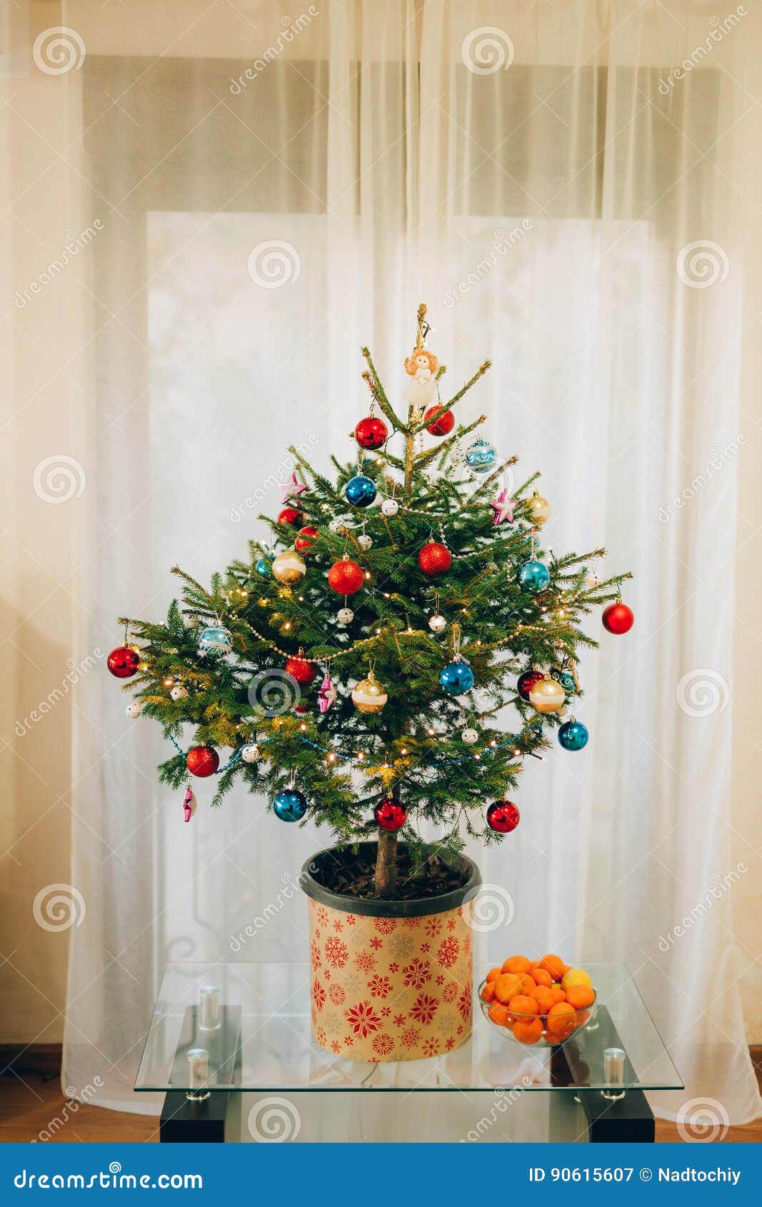 A Small Christmas Tree in a Pot, Decorated with Balls, Garlands Stock
