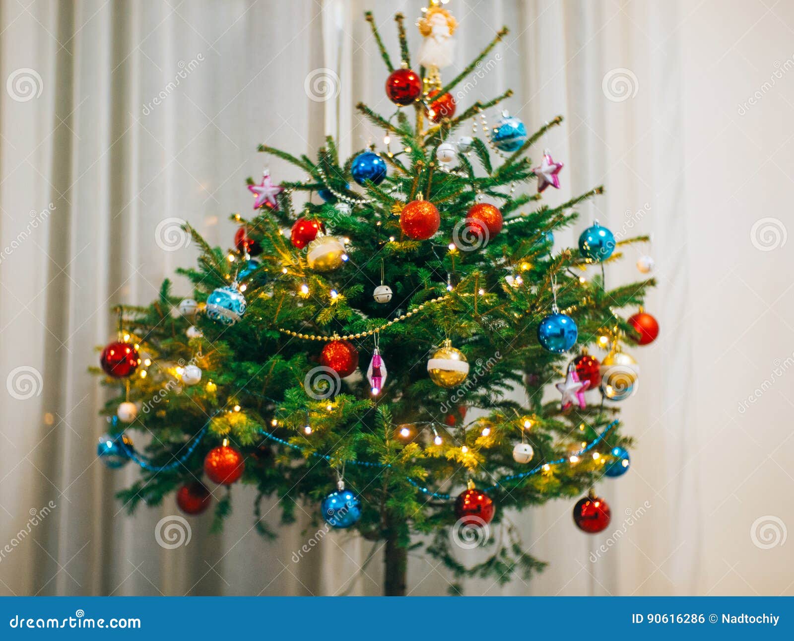 A Small Christmas Tree in a Pot, Decorated with Balls, Garlands Stock