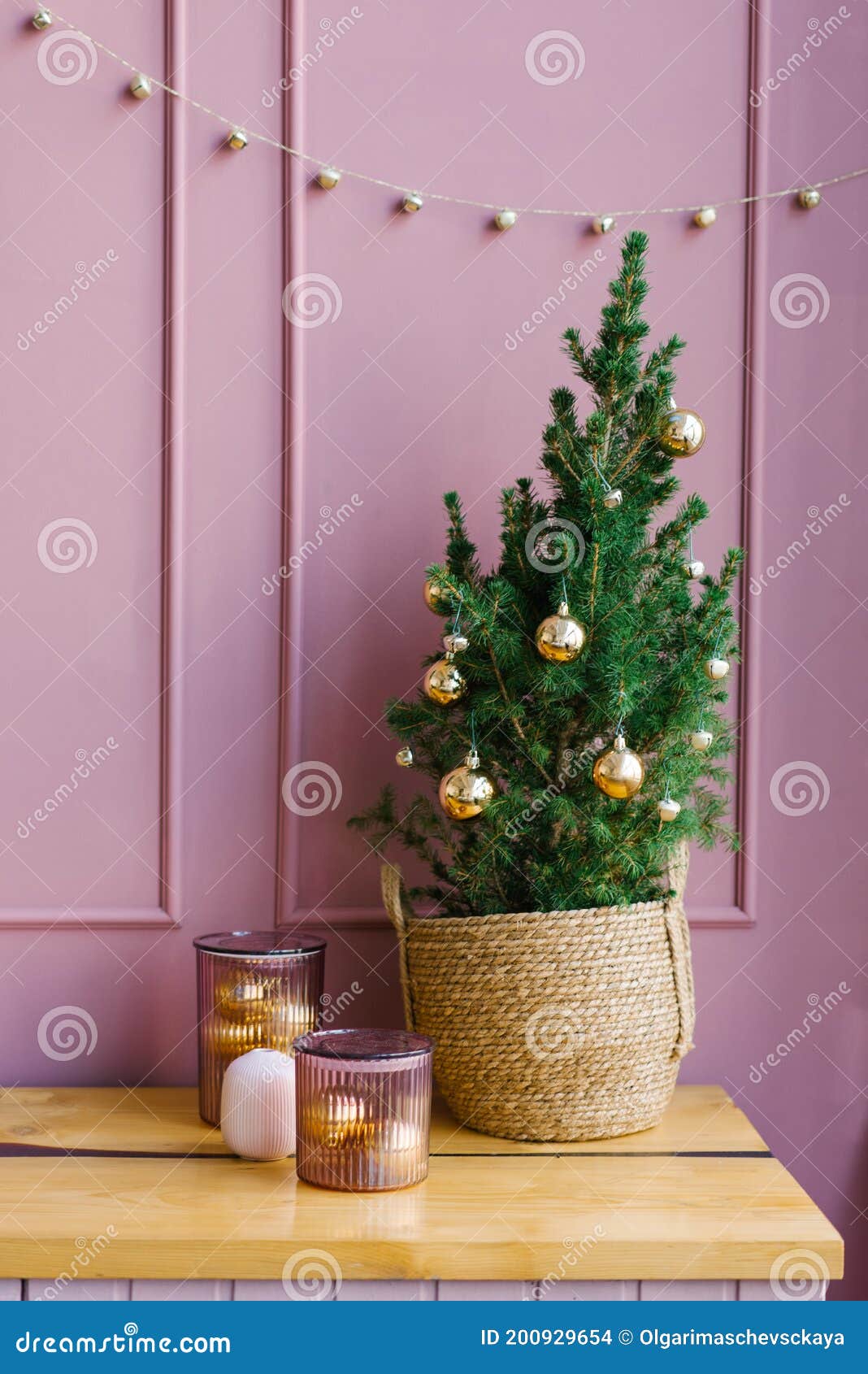 Small Christmas Tree in a Wicker Basket in the Home Decor Stock Photo