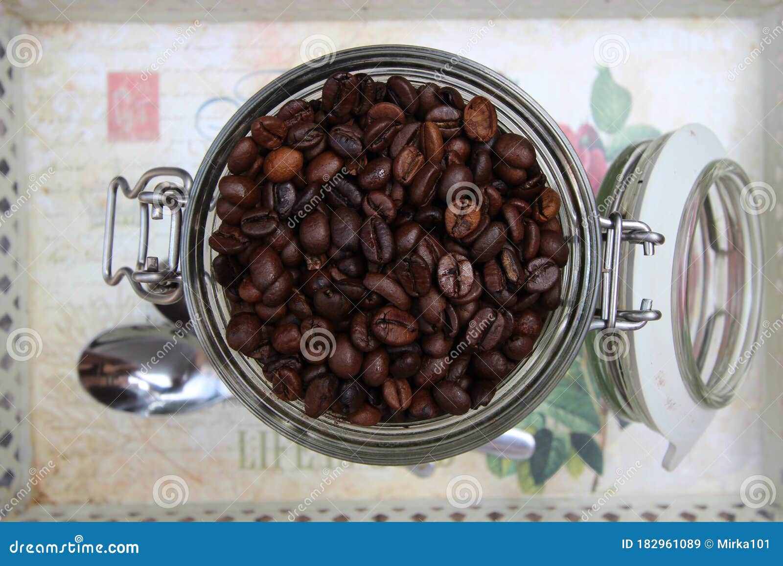 background with many small coffee beans in the jar