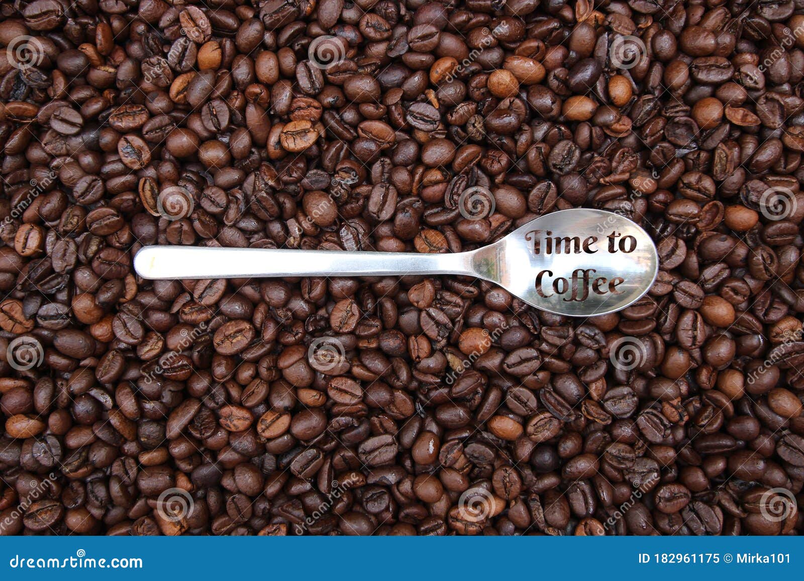 background with many coffee beans and metal spoon
