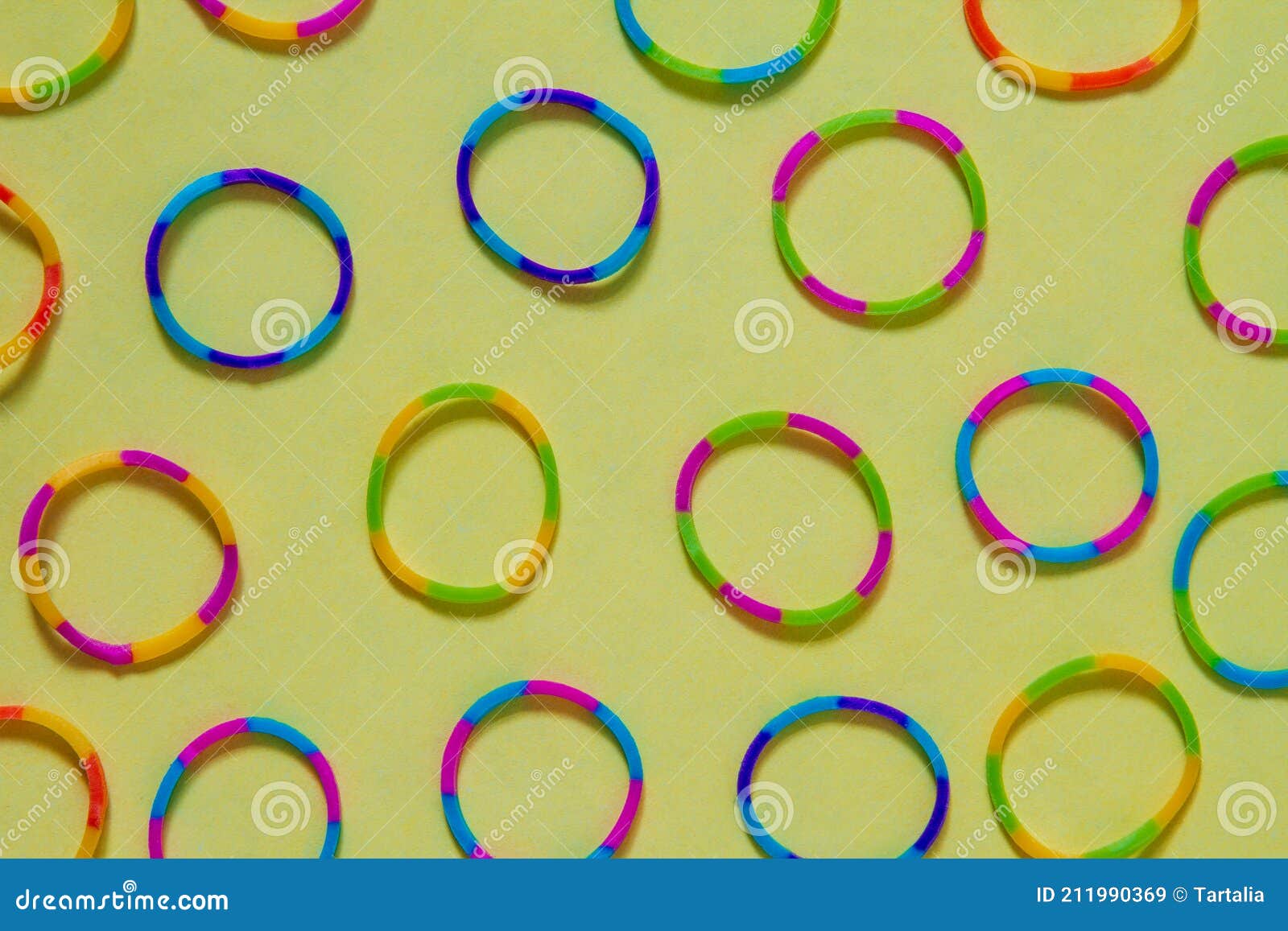 Small Colorful Rubber Rings on a Yellow Background Stock Image Image of blue, colorful 211990369