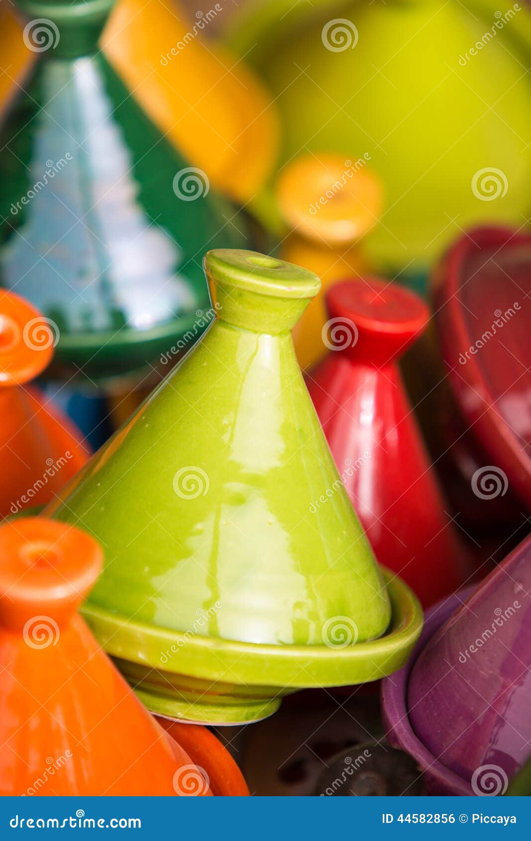 Small coloured Tajines in souk in Marrakesh. Small coloured Tajines, plates and pots made of clay on the market of Tiznit in Morocco