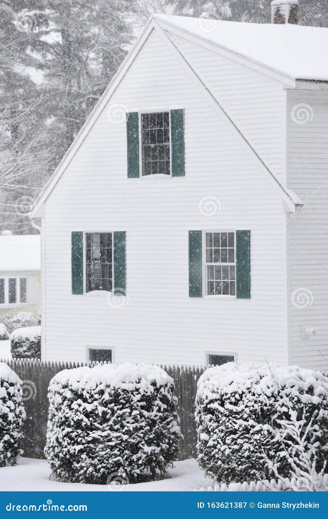 A Small Cozy House Covered With Snow During A Snowfall. Stock Image