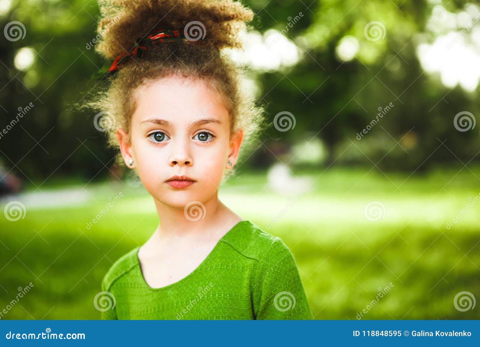 A Small Curly Girl In A Green Dress Stock Image Image Of Girl