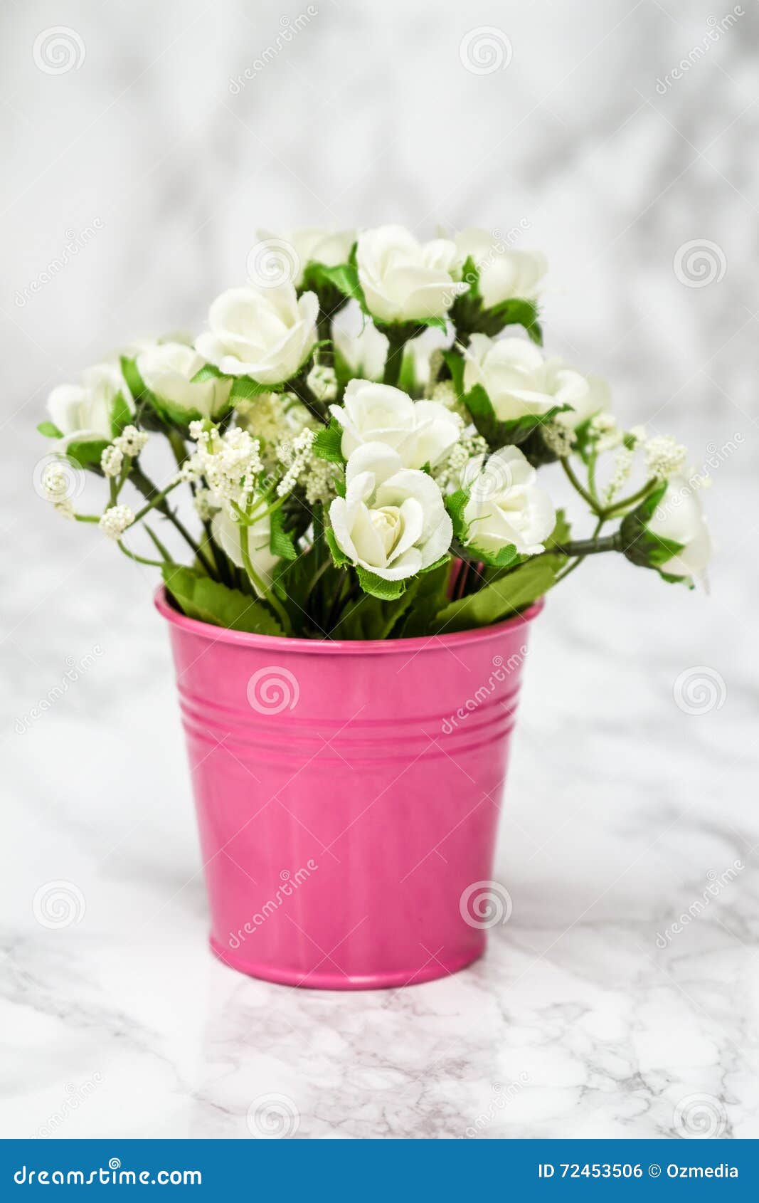 Small Decorative Artificial White Flowers in Pink Pot Stock Photo