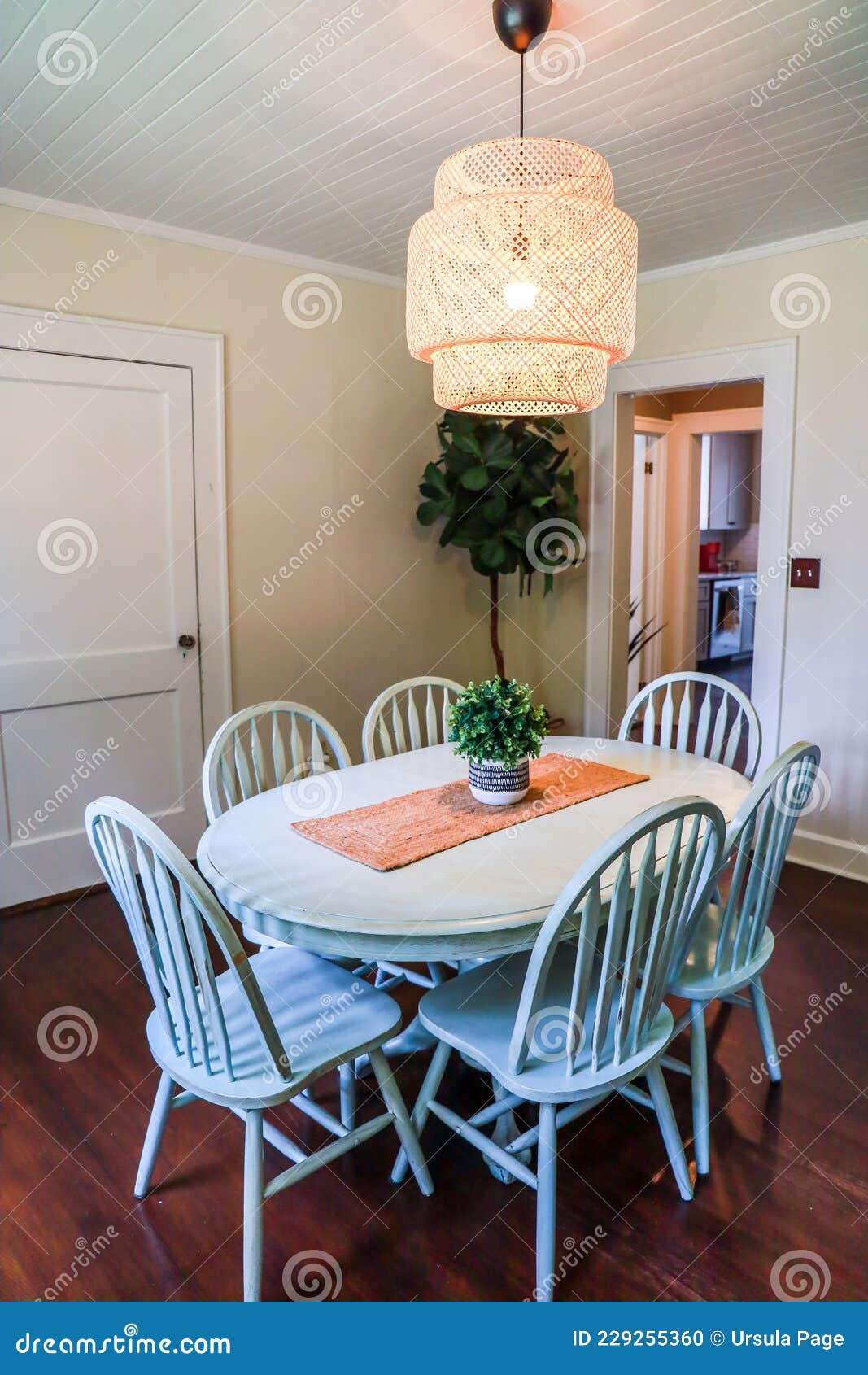 A Small Dining Room with a Statement Rattan Lighting Ficture and a