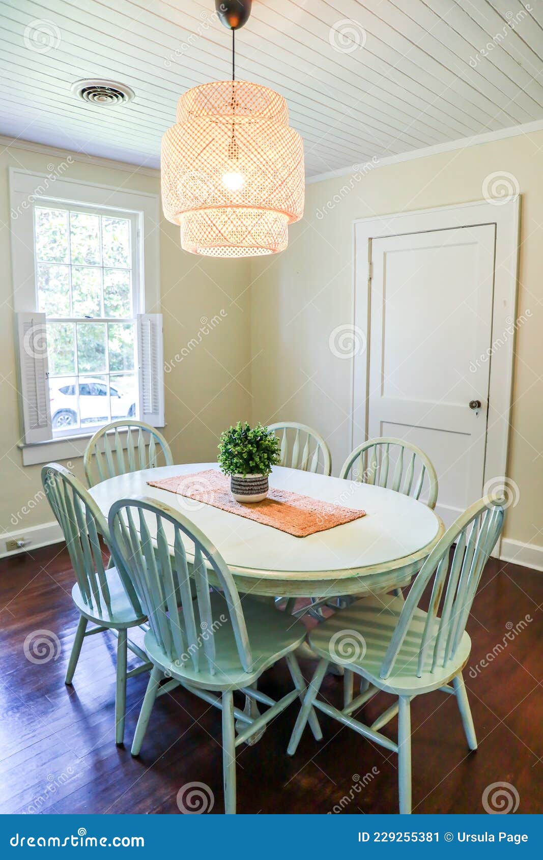 A Small Dining Room with a Statement Rattan Lighting Ficture and a