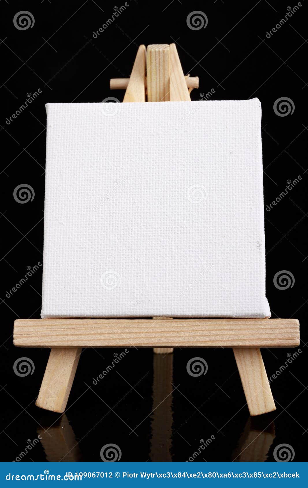 Small Easel with White Blank Cloth on a Wooden Table. Miniature