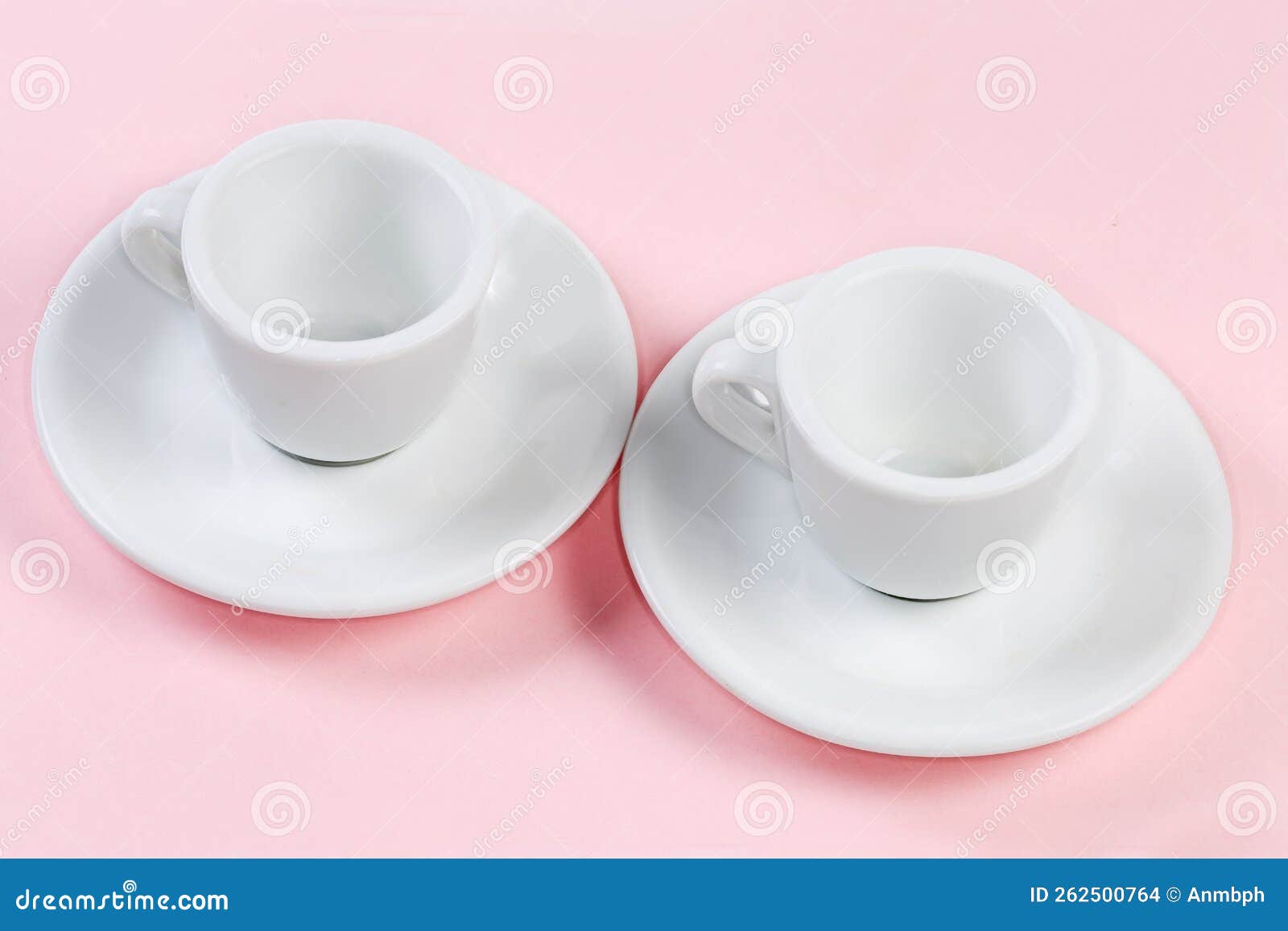 Small Empty White Coffee Cups with Handles on the Saucer Stock Photo