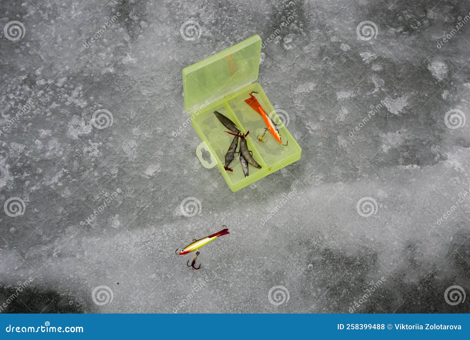 Fishing Lures and Accessories Close Up Near the Ice Hole on the