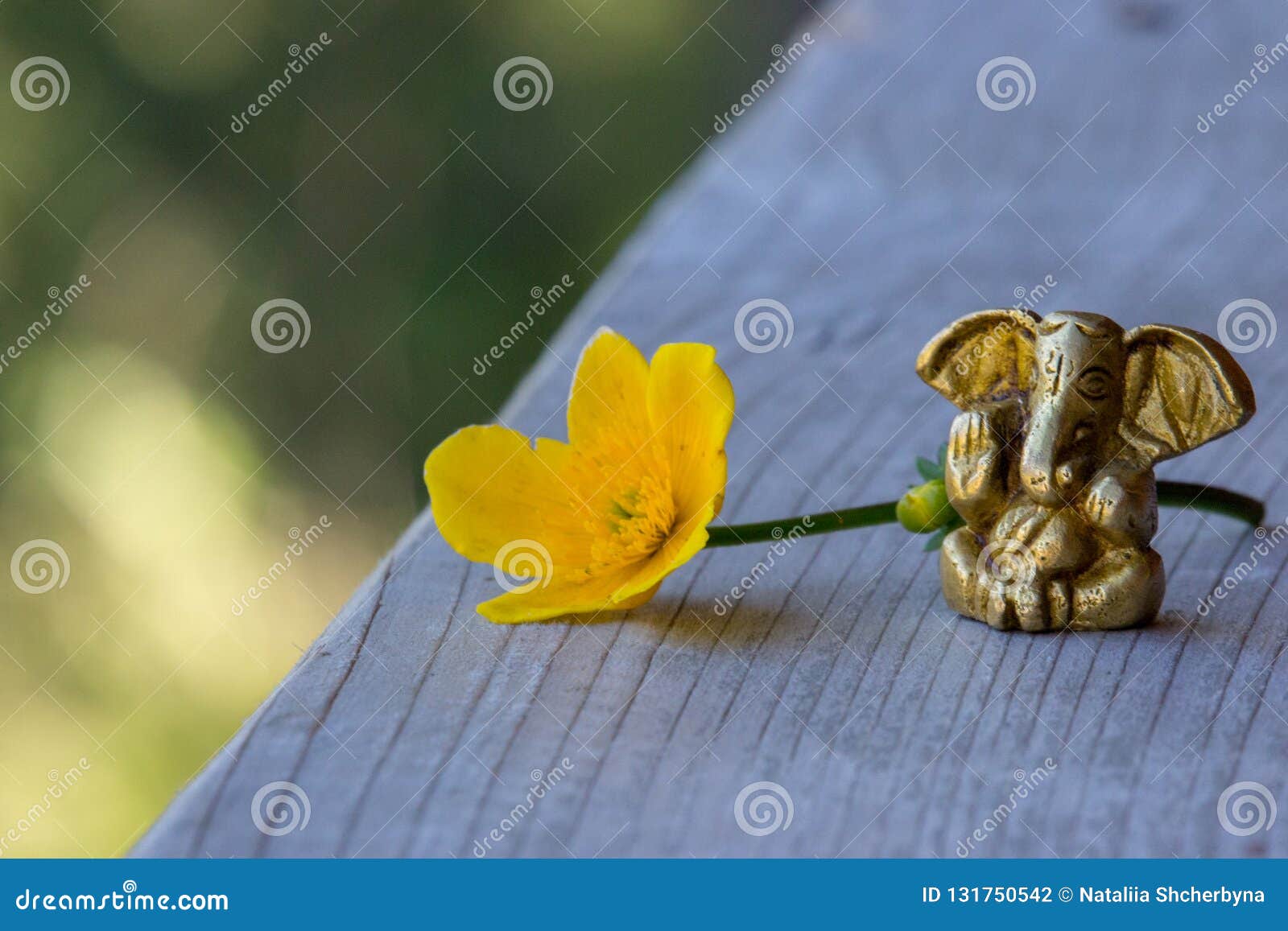 Small Ganesha Figure with Bright Yellow Flower. Beautiful Ganesh ...